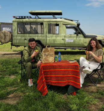 Safari picnic beside a game drive vehicle